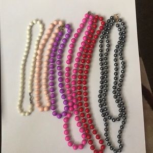 7 different color costume jewelry necklaces.